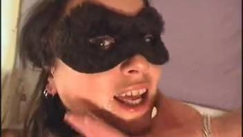 A masked woman is deeply penetrated by her dog